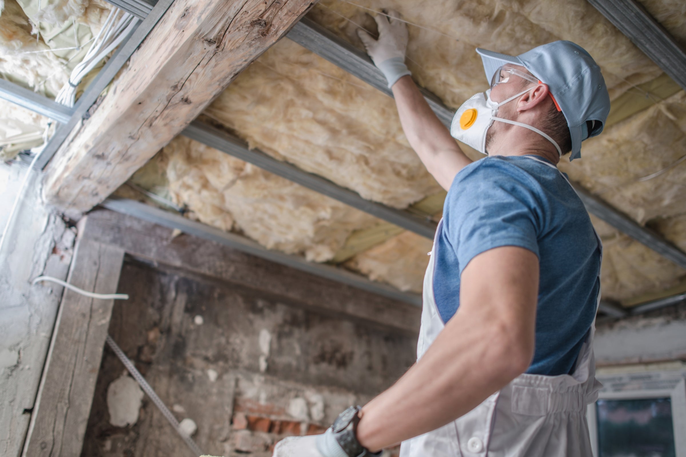 Replacing old attic mineral wool insulation.