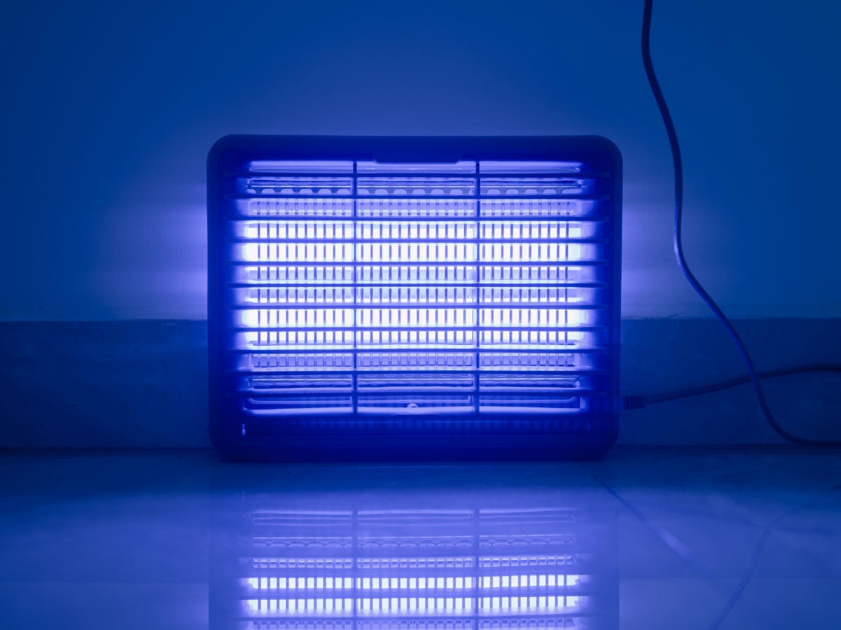 A space heater glowing blue in a dark room