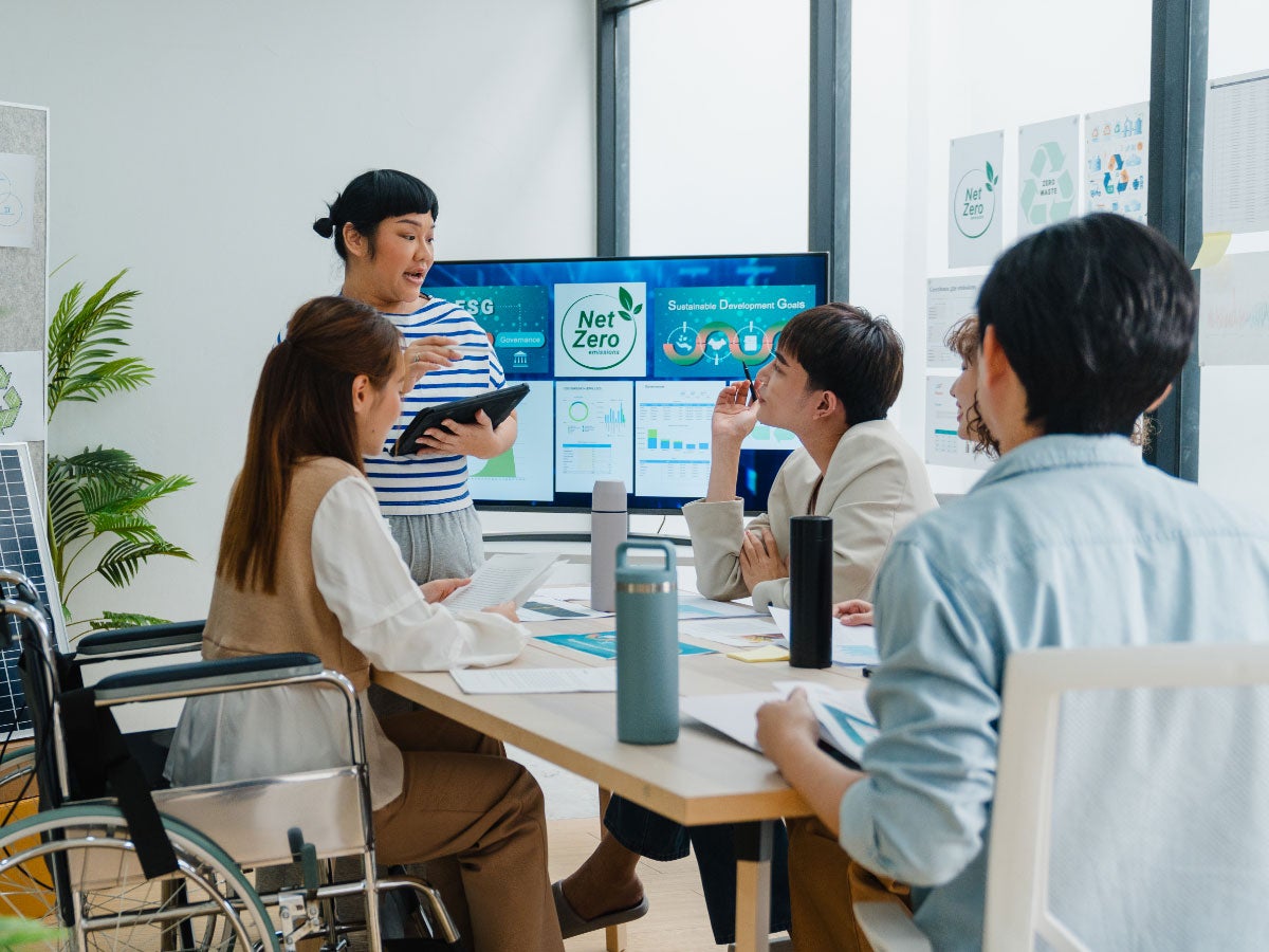Group of colleagues having a meeting about ESG in a contemporary office setting