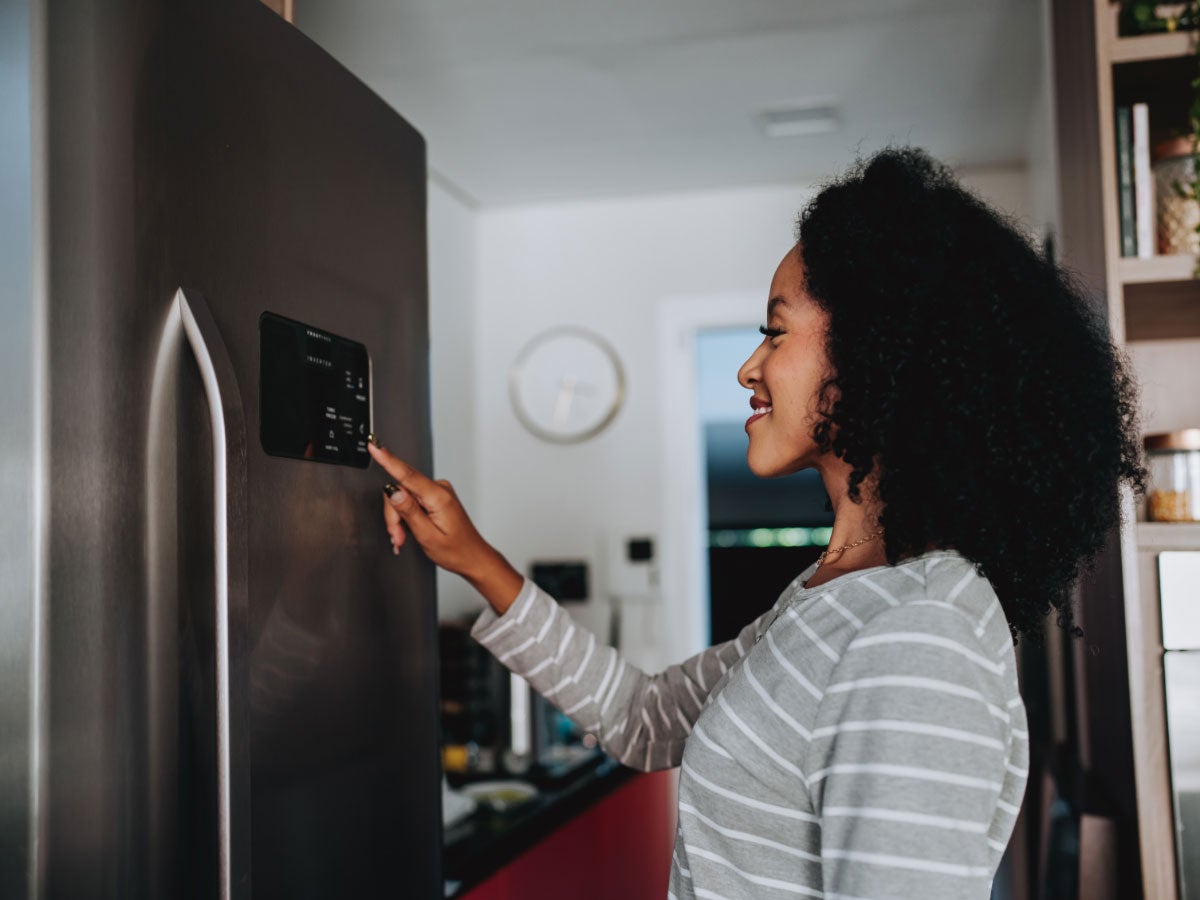 Person using the interface on a smart refrigerator